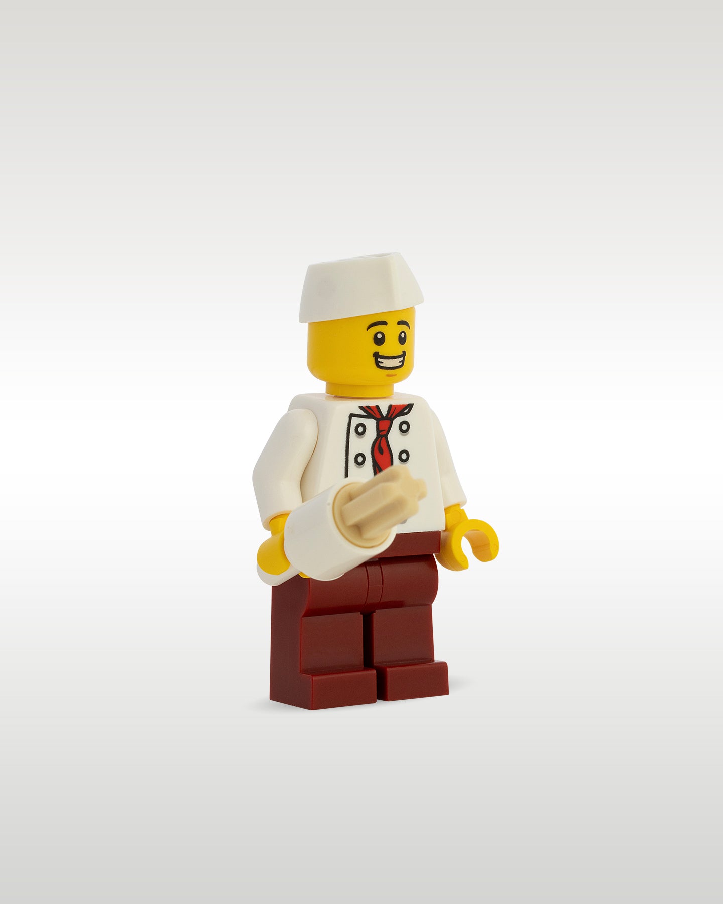 Side profile of the custom toy brick vendor minifigure holding a highly detailed, custom molded micro-scale churro pastry pastry accessory