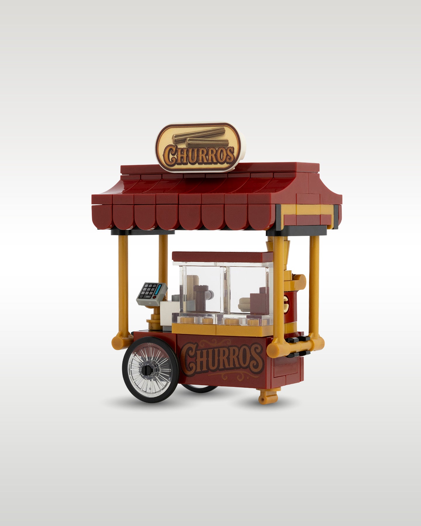 angled view of the custom brick churro cart model, showing the realistic large bicycle-style wheels and structural support pillars