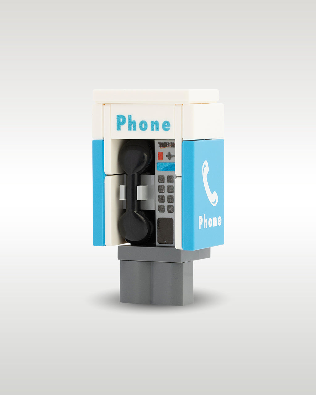 Side perspective view of the Trader Bricks custom MOC city street payphone booth, demonstrating the compact modular scale designed to clip onto custom brick sidewalks