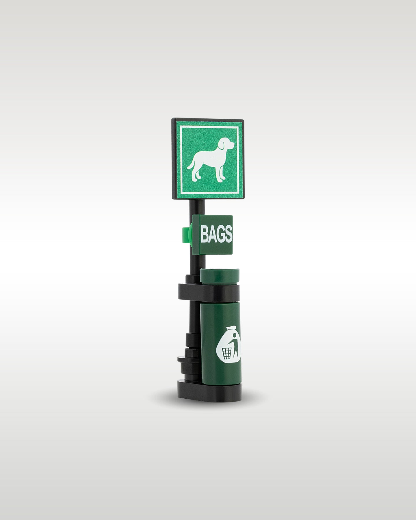 angled profile view of the custom toy brick pet waste station post, showcasing the vertical mounting stand, waste bag box, and trash receptacle details