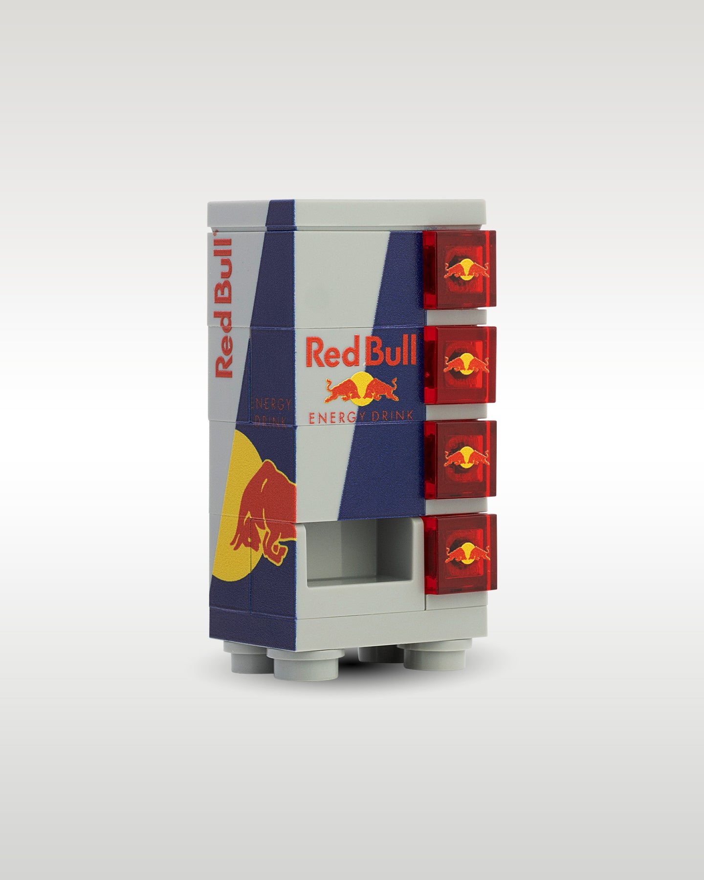 angled profile view of the custom toy brick energy drink vending machine, showcasing the side graphics panel, collection slot, and printed red selection tiles