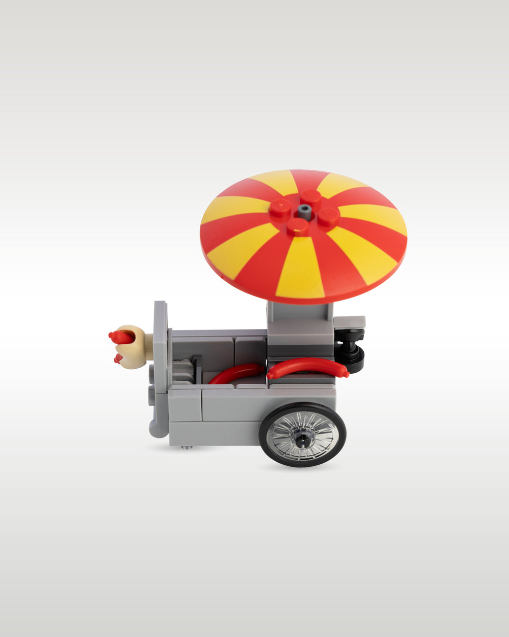 High-angle top-down view of the custom hot dog stand, highlighting the classic red and yellow striped umbrella pattern