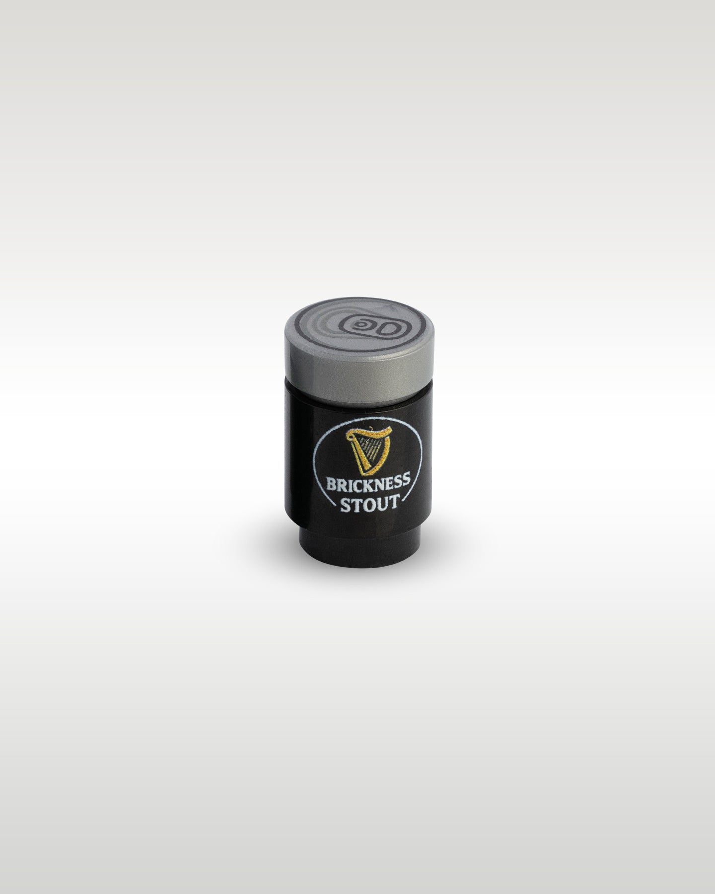 High-angle perspective of the black Brickness Stout custom toy brick can by Trader Bricks, highlighting the detailed silver pull-tab printed top lid