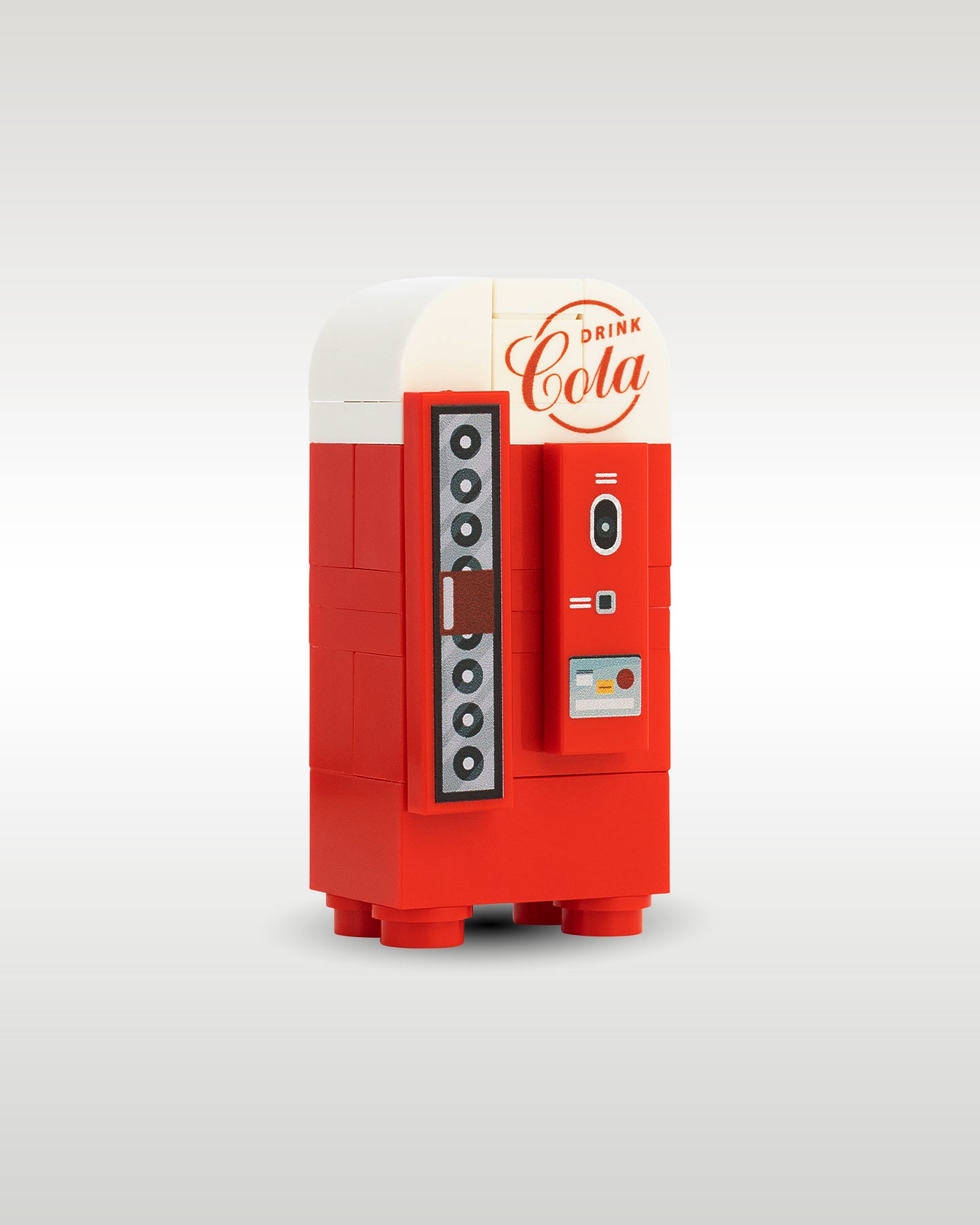 angled profile view of the custom toy brick retro soda machine, showcasing the white rounded top, vintage script logo print, and vertical bottle selection mechanism