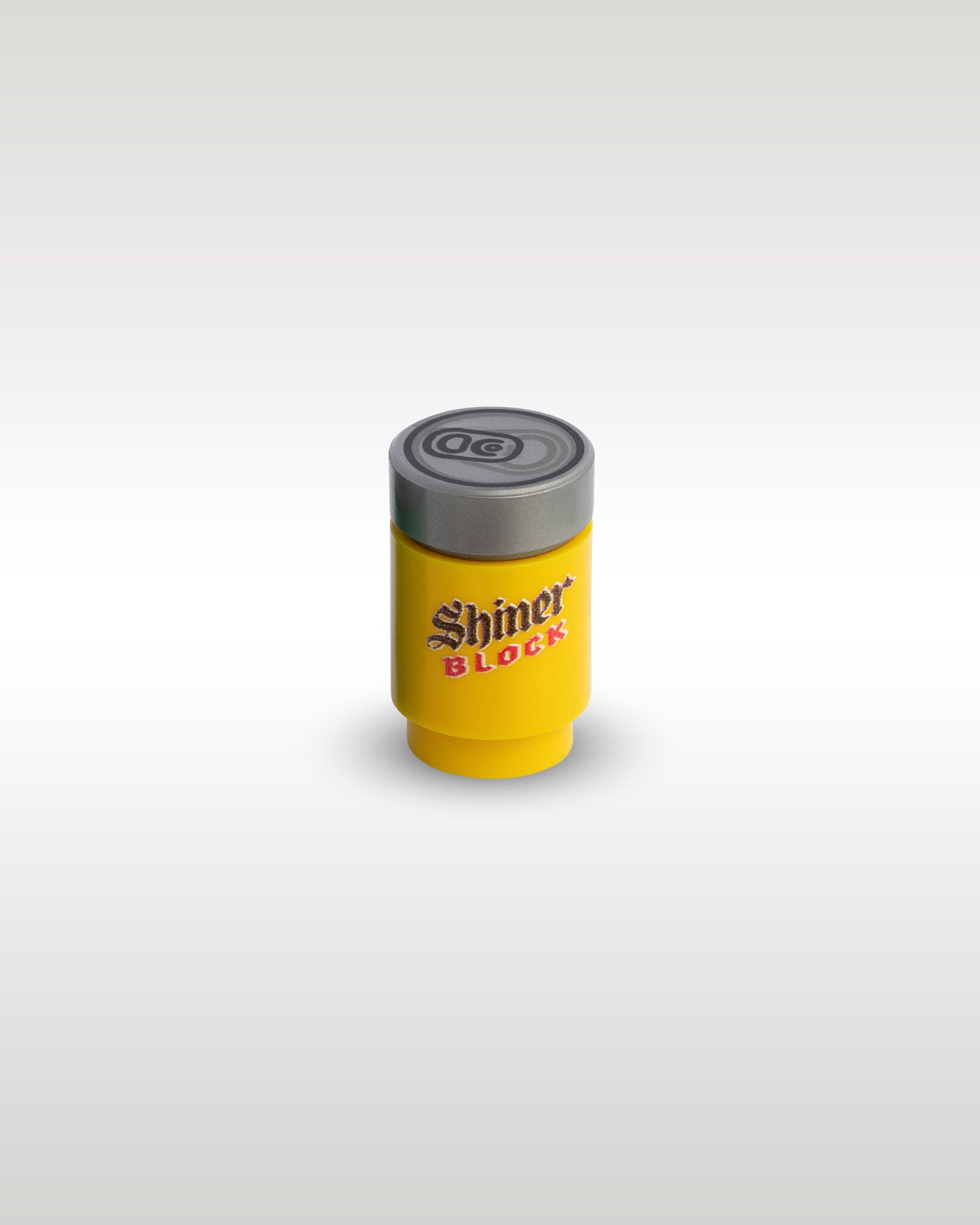 High-angle perspective of the yellow Shiner Block custom toy brick can by Trader Bricks, showcasing the detailed silver pull-tab printed top lid
