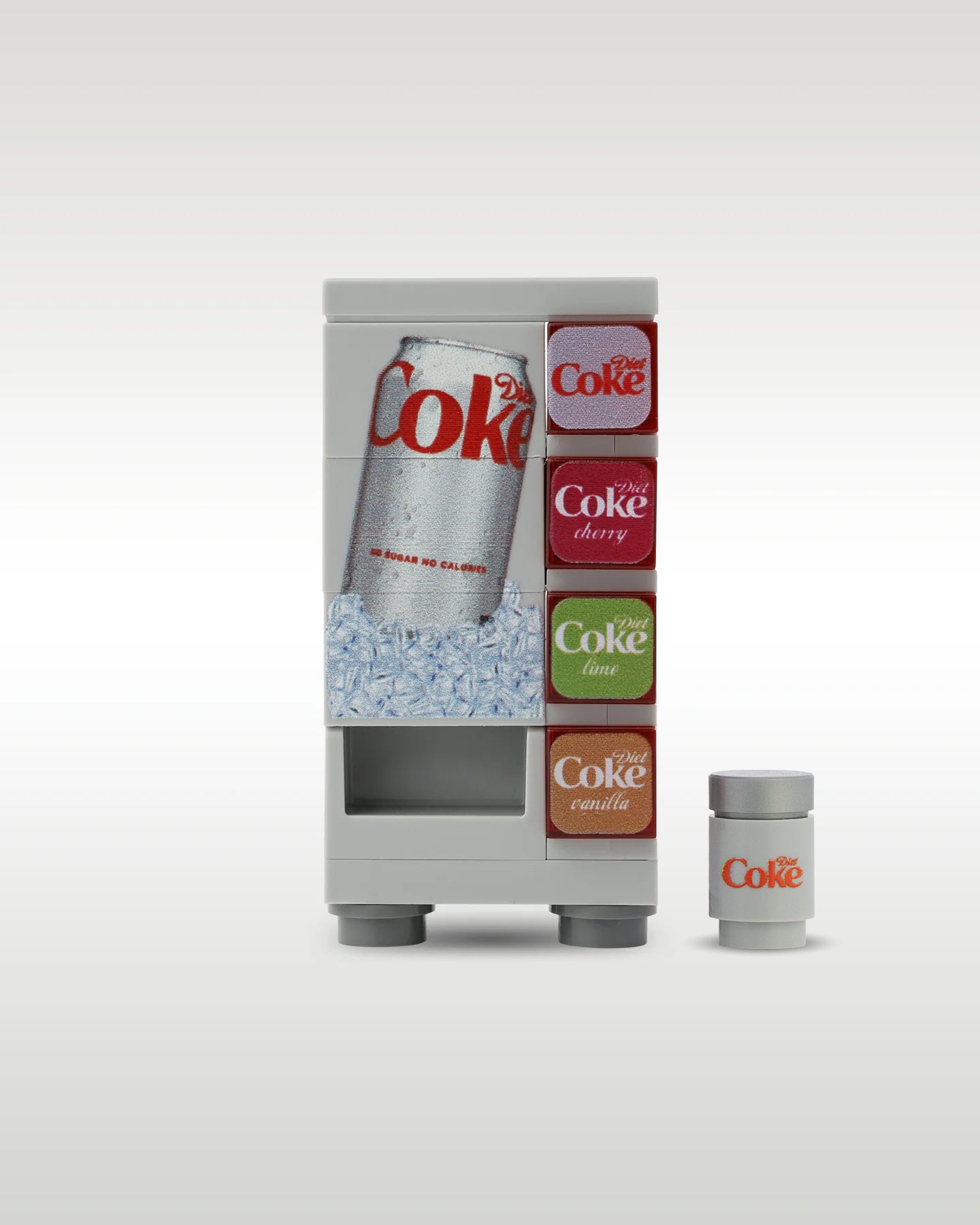 Custom brick-built Diet Coke soda vending machine MOC set by Trader Bricks, featuring a silver can on an ice graphic panel and a matching miniature light grey soda can accessory