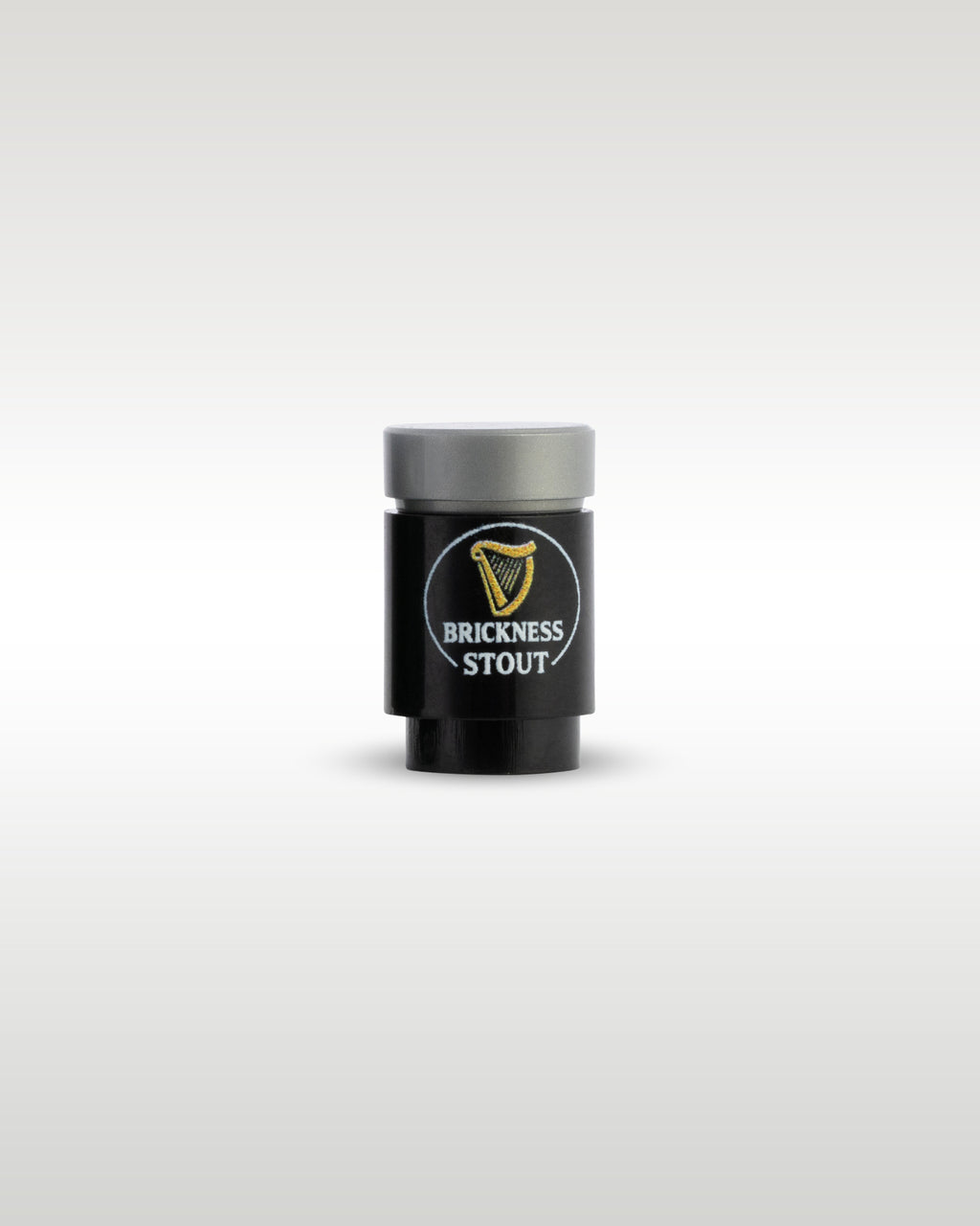 Custom printed Brickness Stout beer can accessory by Trader Bricks, featuring a gold harp parody logo on a black 1x1 round brick for Lego minifigures