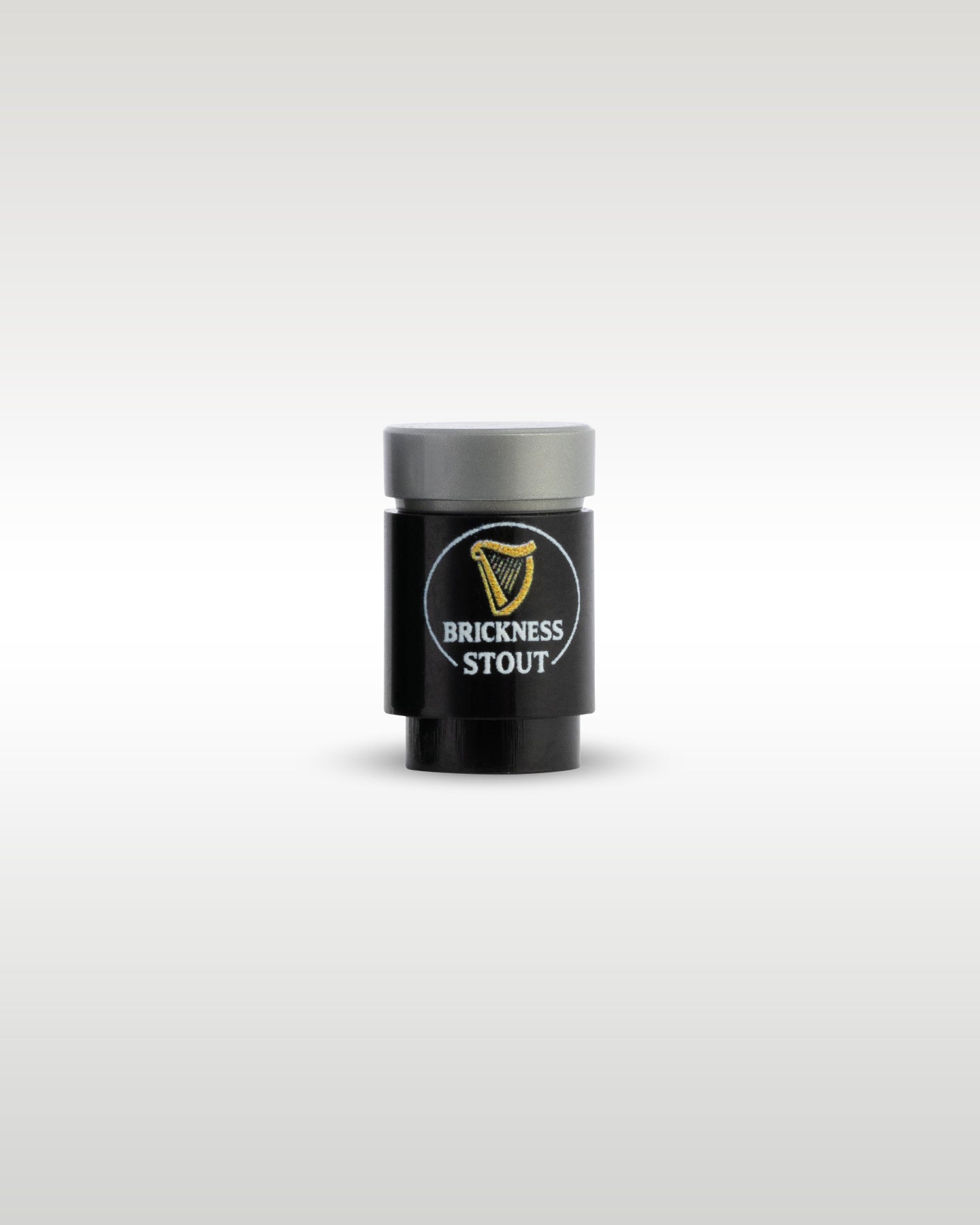 Custom printed Brickness Stout beer can accessory by Trader Bricks, featuring a gold harp parody logo on a black 1x1 round brick for Lego minifigures
