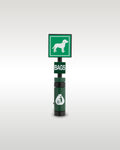 Custom brick-built pet clean up station model by Trader Bricks, featuring a green square sign with a custom printed white dog graphic, a 'BAGS' dispenser tile, and a dark green trash bin