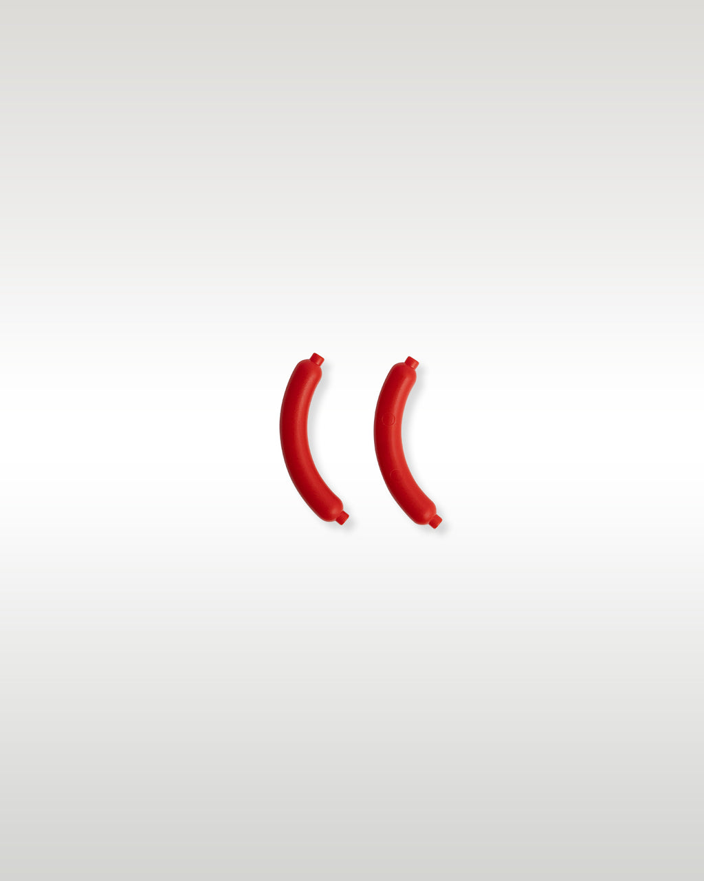 Two custom molded reddish-brown micro-scale hot dog sausage food accessories included with the Trader Bricks street vendor set