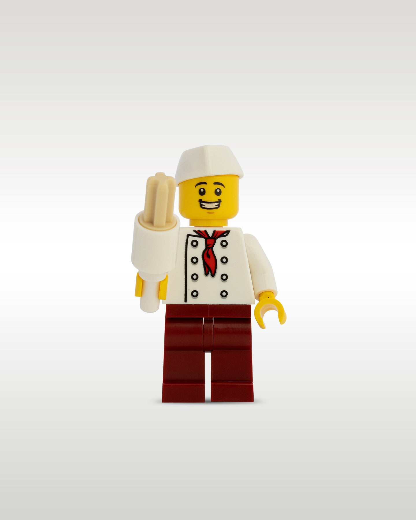 Custom printed theme park street food vendor minifigure by Trader Bricks, wearing a white chef uniform with a red tie, dark red pants, and a white service cap